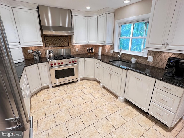 1027 Hart Rd, Baltimore, MD 21286 - kitchen featuring wall chimney range hood, appliances with stainless steel finishes, a sink, white cabinetry, and decorative backsplash