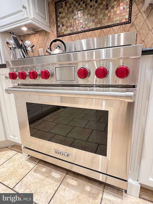 1027 Hart Rd, Baltimore, MD 21286 - kitchen view of premium range, backsplash, and white cabinetry