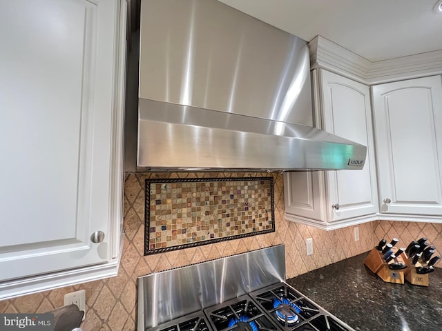 1027 Hart Rd, Baltimore, MD 21286 - kitchen view of wall chimney range hood, white cabinets, decorative backsplash, dark stone countertops, and stove