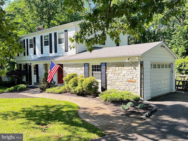 1027 Hart Rd, Baltimore, MD 21286 - view of front of home featuring stone siding, a garage, driveway, a chimney, and a front yard