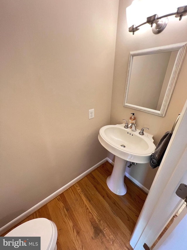 1027 Hart Rd, Baltimore, MD 21286 - half bath featuring toilet, wood finished floors, and baseboards