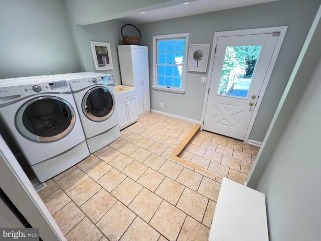 1027 Hart Rd, Baltimore, MD 21286 - laundry area featuring cabinet space, independent washer and dryer, light tile patterned floors, and baseboards