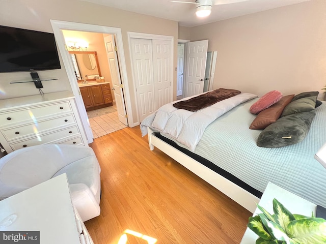 1027 Hart Rd, Baltimore, MD 21286 - bedroom featuring light wood-type flooring, a closet, a sink, and ensuite bath