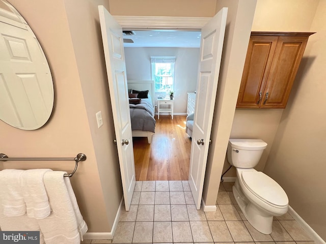 1027 Hart Rd, Baltimore, MD 21286 - half bathroom featuring toilet, baseboards, and tile patterned floors