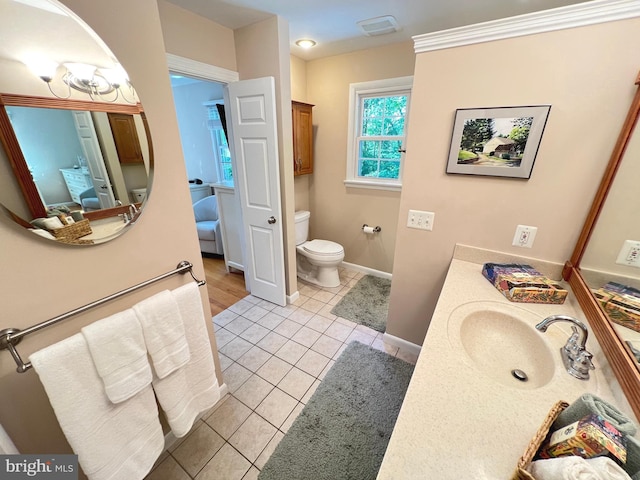 1027 Hart Rd, Baltimore, MD 21286 - bathroom featuring connected bathroom, toilet, vanity, tile patterned floors, and baseboards