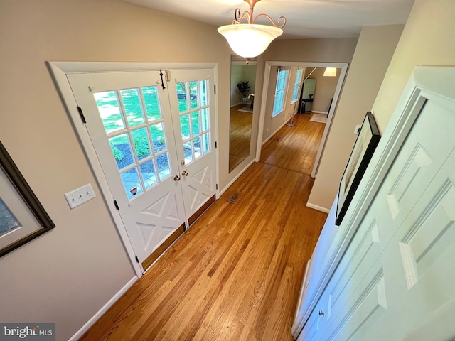 1027 Hart Rd, Baltimore, MD 21286 - doorway featuring french doors, light wood finished floors, and baseboards