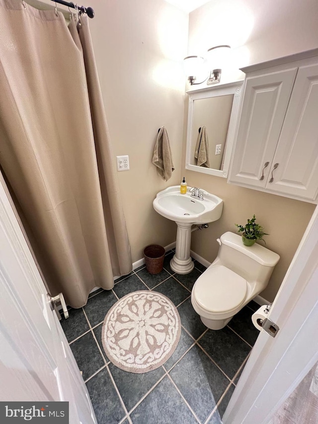 1027 Hart Rd, Baltimore, MD 21286 - bathroom with toilet, tile patterned flooring, and baseboards