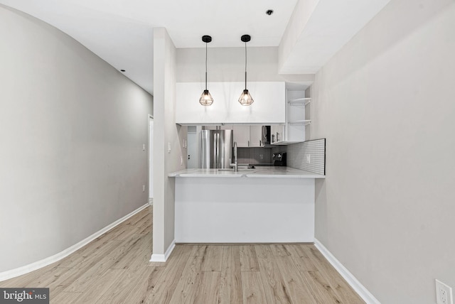 234 N 3rd St Unit 401, Philadelphia, PA 19106 - kitchen with stainless steel appliances, wood finished floors, open shelves, decorative backsplash, and pendant lighting