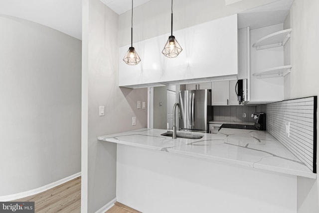 234 N 3rd St Unit 401, Philadelphia, PA 19106 - kitchen with electric range, freestanding refrigerator, a sink, open shelves, and light stone counters