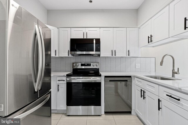 234 N 3rd St Unit 401, Philadelphia, PA 19106 - kitchen featuring stainless steel appliances, a sink, white cabinetry, and tasteful backsplash