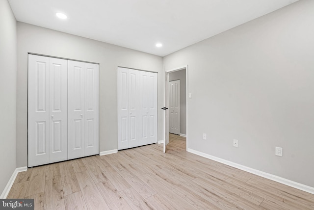 234 N 3rd St Unit 401, Philadelphia, PA 19106 - unfurnished bedroom with two closets, baseboards, light wood-style flooring, and recessed lighting