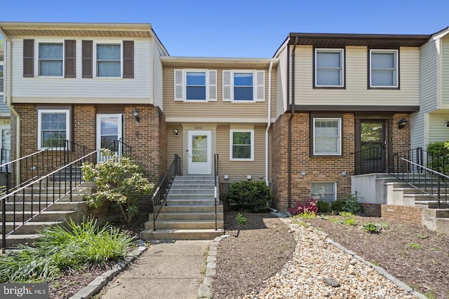 townhome / multi-family property with brick siding