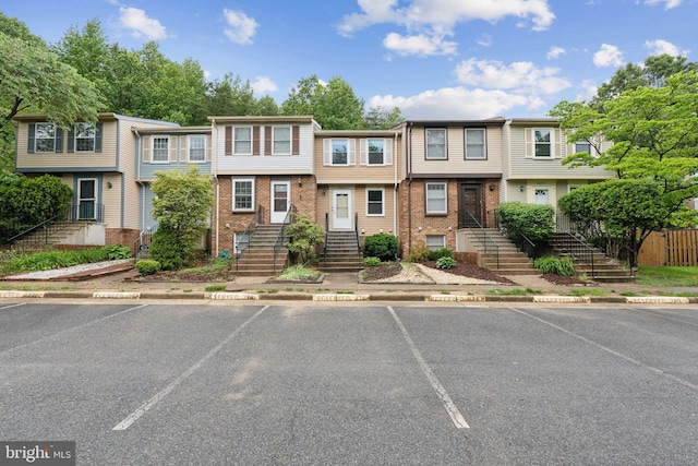 6842 Heatherway Ct, Alexandria, VA 22315 - townhome / multi-family property featuring uncovered parking, brick siding, stairway, and a residential view