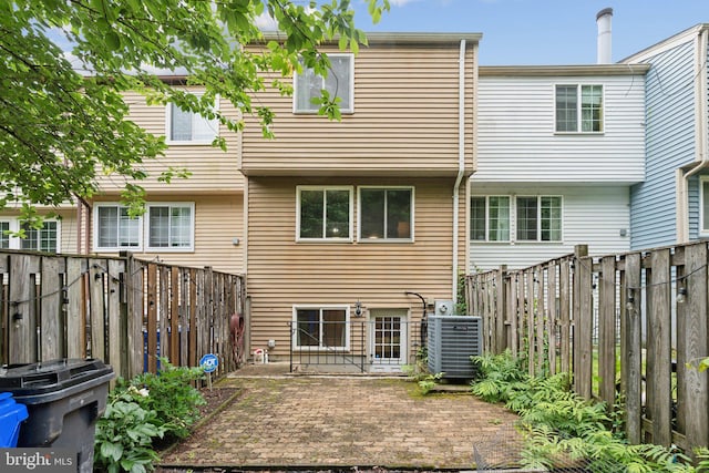 6842 Heatherway Ct, Alexandria, VA 22315 - back of house featuring central AC unit, a fenced backyard, and a patio area
