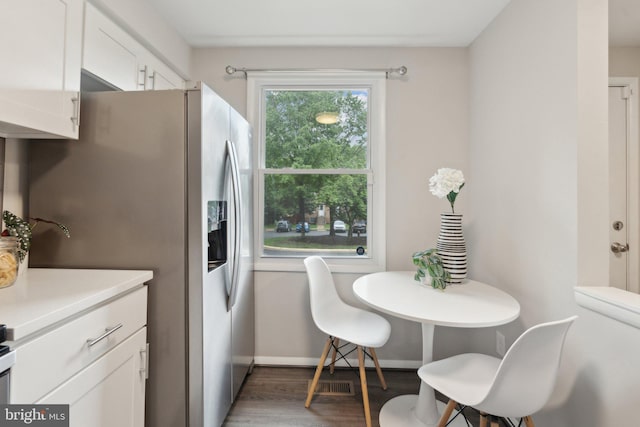 6842 Heatherway Ct, Alexandria, VA 22315 - kitchen featuring wood finished floors, light countertops, white cabinetry, stainless steel refrigerator with ice dispenser, and baseboards