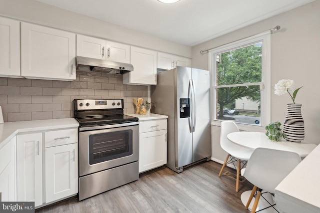 6842 Heatherway Ct, Alexandria, VA 22315 - kitchen with appliances with stainless steel finishes, under cabinet range hood, light countertops, and white cabinets