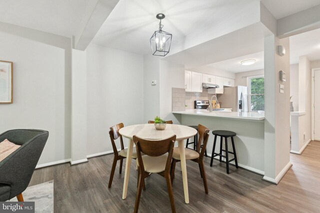 6842 Heatherway Ct, Alexandria, VA 22315 - dining area featuring wood finished floors, baseboards, and a chandelier
