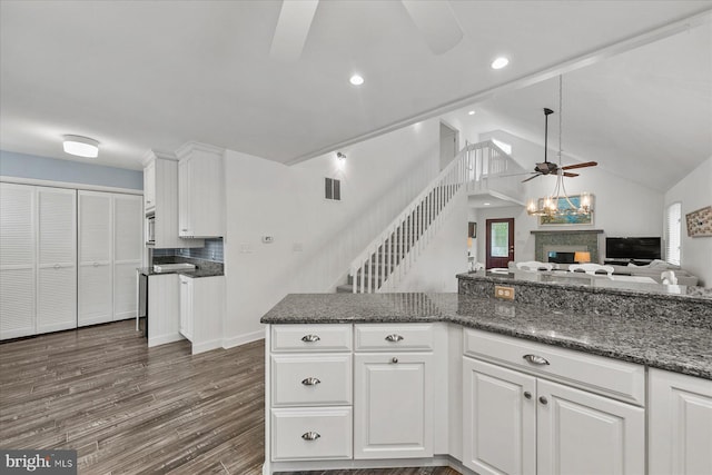 537 Candlelight Ln, Bethany Beach, DE 19930 - kitchen featuring a ceiling fan, white cabinetry, a fireplace, open floor plan, and dark wood finished floors