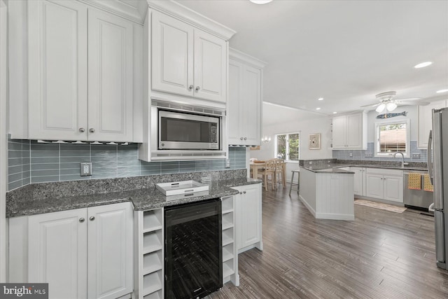 537 Candlelight Ln, Bethany Beach, DE 19930 - kitchen with wine cooler, open shelves, a sink, appliances with stainless steel finishes, and white cabinetry