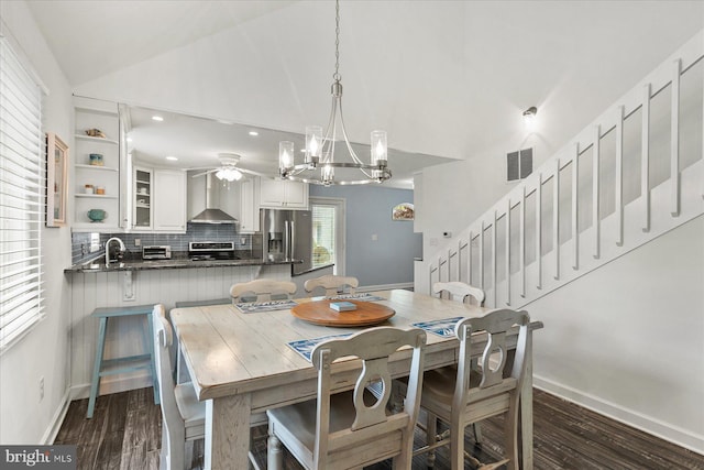537 Candlelight Ln, Bethany Beach, DE 19930 - dining space with ceiling fan, stairs, dark wood-style flooring, a chandelier, and high vaulted ceiling