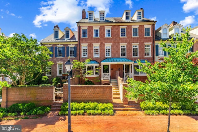 54 Wolfe St, Alexandria, VA 22314 - view of front of house featuring a chimney, brick siding, and a gate