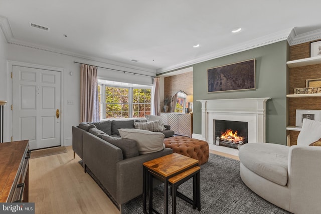 54 Wolfe St, Alexandria, VA 22314 - living area with ornamental molding, light wood-type flooring, a fireplace with flush hearth, and recessed lighting