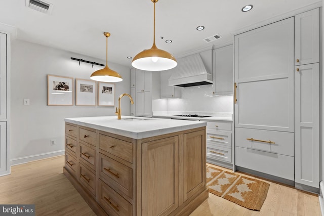 54 Wolfe St, Alexandria, VA 22314 - kitchen featuring premium range hood, a sink, recessed lighting, light wood finished floors, and white gas stovetop