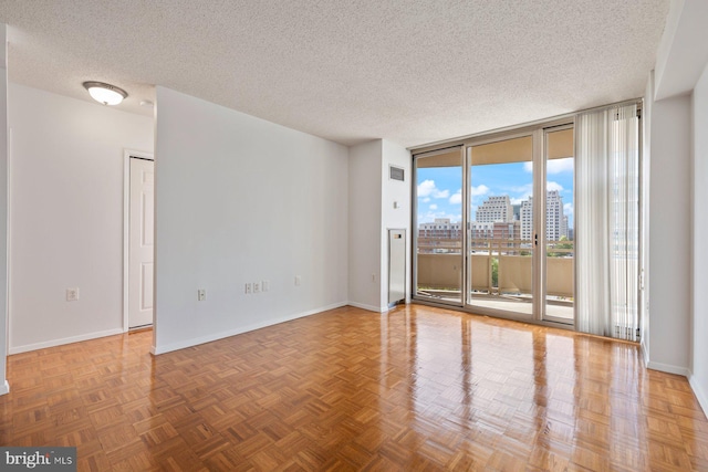 4801 Fairmont Ave Unit 804, Bethesda, MD 20814 - unfurnished room featuring floor to ceiling windows, a textured ceiling, baseboards, and a city view