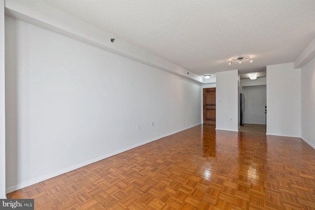 4801 Fairmont Ave Unit 804, Bethesda, MD 20814 - spare room with a textured ceiling and baseboards