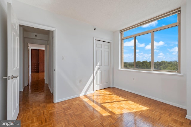 4801 Fairmont Ave Unit 804, Bethesda, MD 20814 - unfurnished bedroom featuring baseboards, a textured ceiling, and a closet