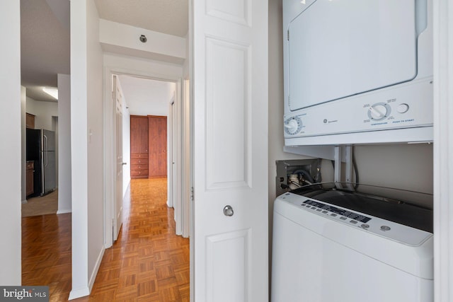4801 Fairmont Ave Unit 804, Bethesda, MD 20814 - washroom with stacked washer / dryer and baseboards