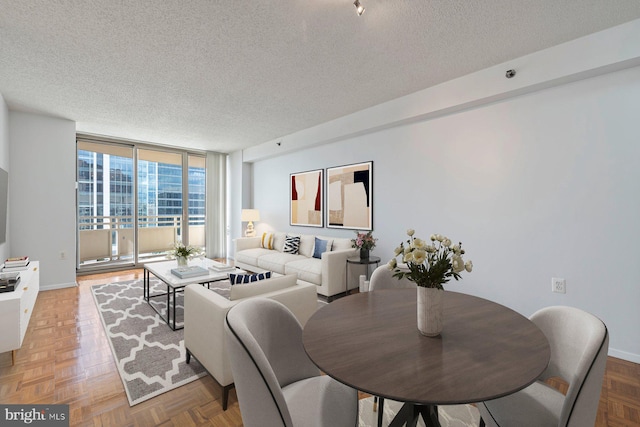 4801 Fairmont Ave Unit 804, Bethesda, MD 20814 - dining area featuring a textured ceiling, expansive windows, and baseboards