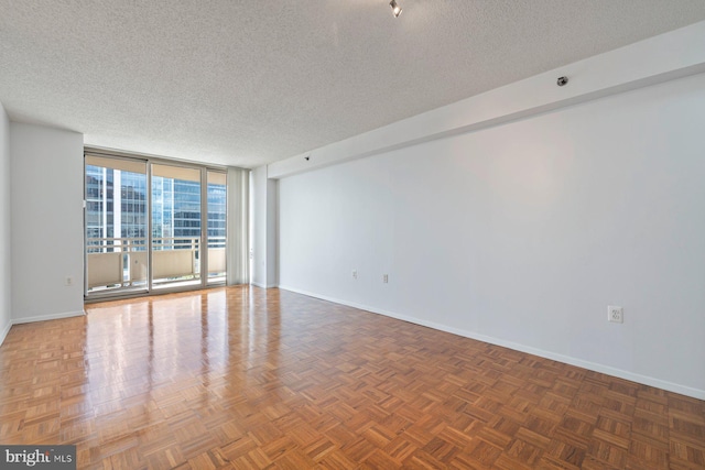 4801 Fairmont Ave Unit 804, Bethesda, MD 20814 - empty room featuring a textured ceiling, baseboards, and floor to ceiling windows