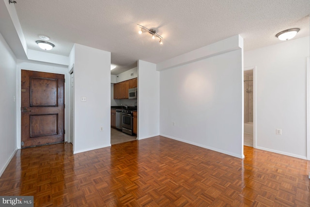 4801 Fairmont Ave Unit 804, Bethesda, MD 20814 - unfurnished living room featuring baseboards and a textured ceiling