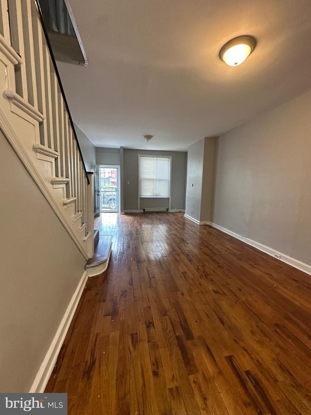 1528 W Oakdale St, Philadelphia, PA 19132 - unfurnished living room featuring hardwood / wood-style floors, baseboards, and stairway