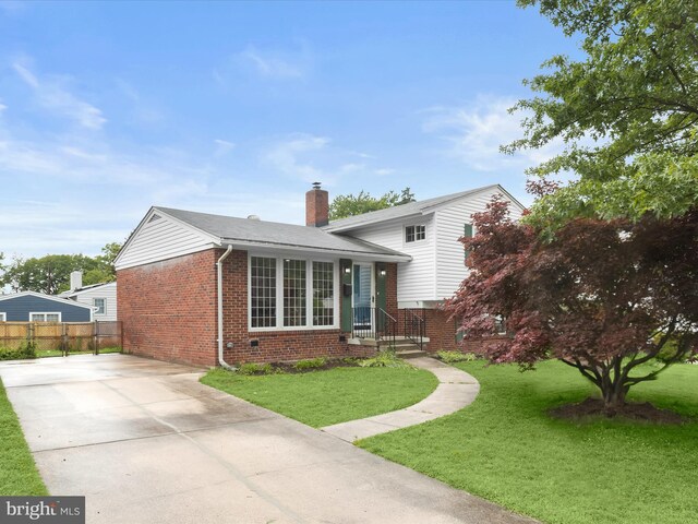 13214 Holdridge Rd, Silver Spring, MD 20906 - view of front of home featuring brick siding, a chimney, and driveway