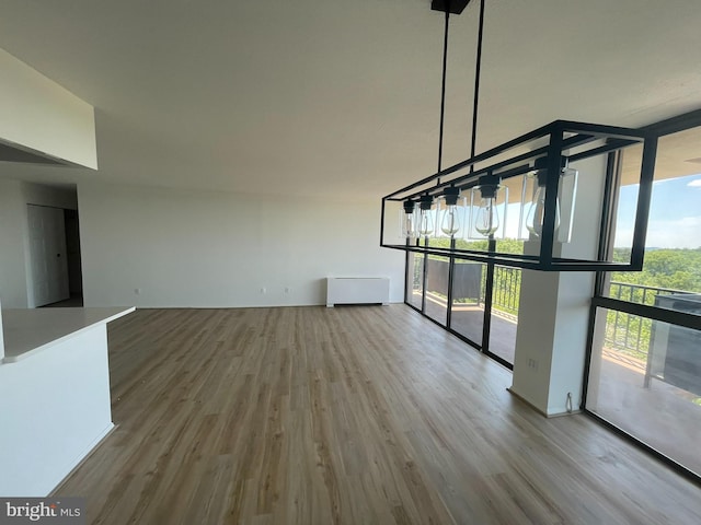 unfurnished living room featuring wood finished floors and expansive windows