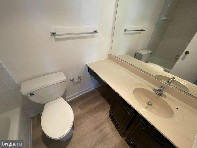 bathroom featuring toilet, vanity, baseboards, a shower, and a tub