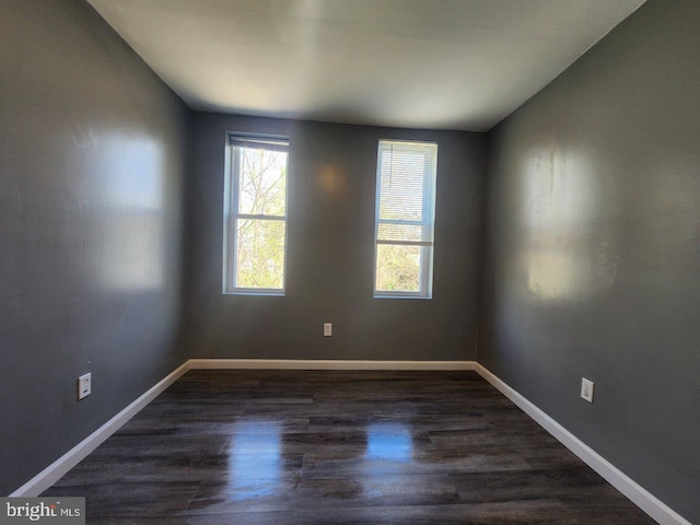 713 N Payson St, Baltimore, MD 21217 - empty room with dark wood-style flooring, baseboards, and lofted ceiling