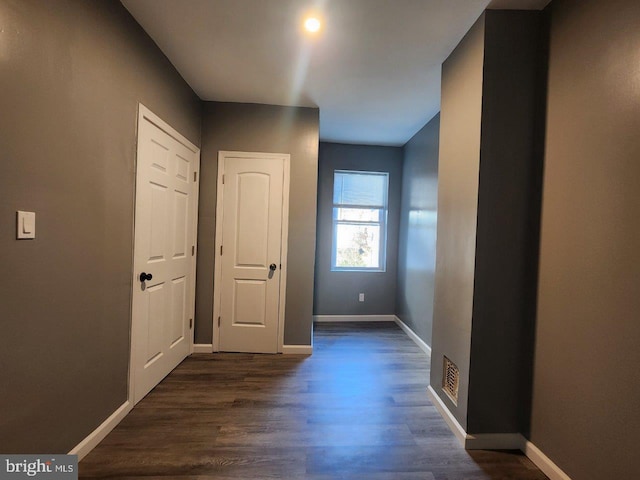 713 N Payson St, Baltimore, MD 21217 - hall featuring dark wood-style floors and baseboards