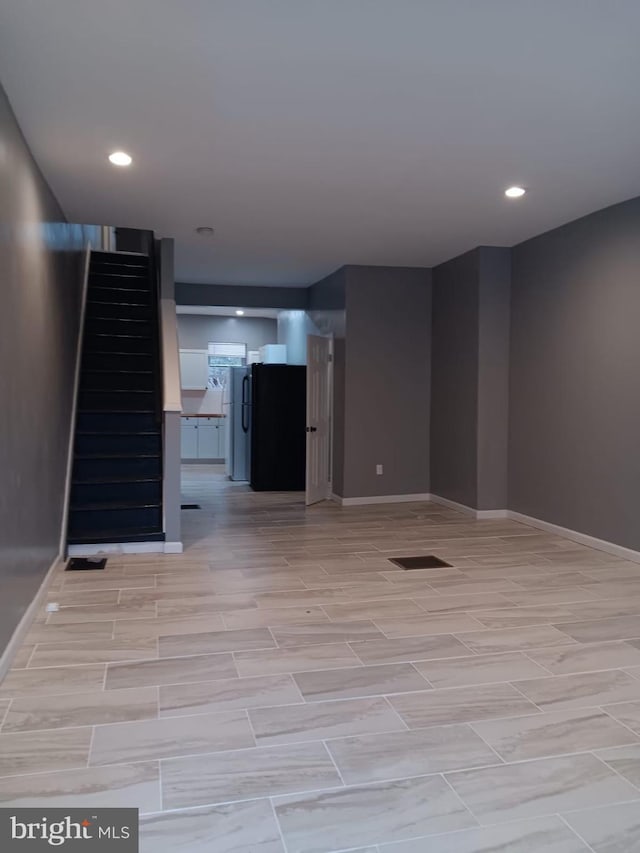 713 N Payson St, Baltimore, MD 21217 - unfurnished living room with stairway, baseboards, and recessed lighting