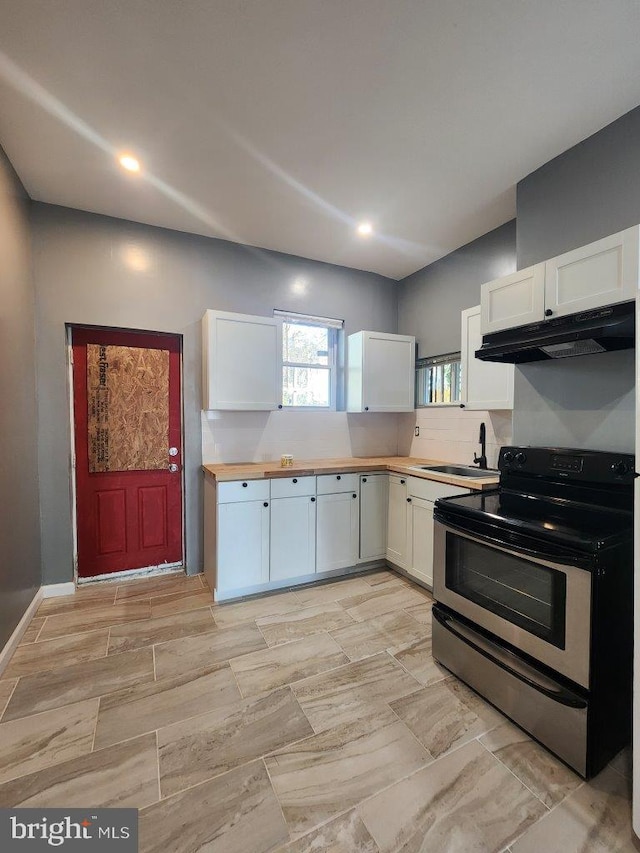 713 N Payson St, Baltimore, MD 21217 - kitchen with electric range, under cabinet range hood, white cabinetry, a sink, and recessed lighting