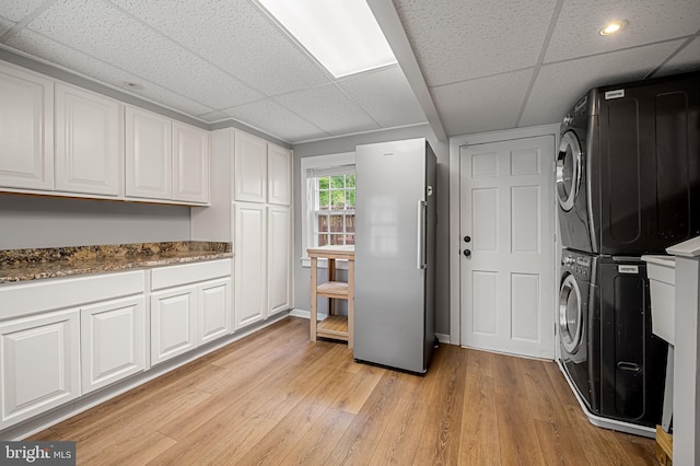 1602 S Rolling Rd, Halethorpe, MD 21227 - laundry room featuring stacked washer / dryer, light wood-style flooring, recessed lighting, and baseboards