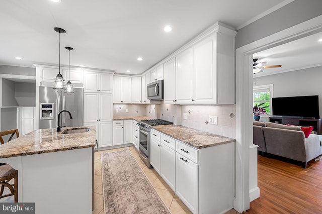 1602 S Rolling Rd, Halethorpe, MD 21227 - kitchen with appliances with stainless steel finishes, a sink, a kitchen bar, decorative backsplash, and ornamental molding