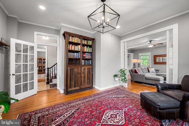 1602 S Rolling Rd, Halethorpe, MD 21227 - living area with wood finished floors, a chandelier, crown molding, recessed lighting, and baseboards