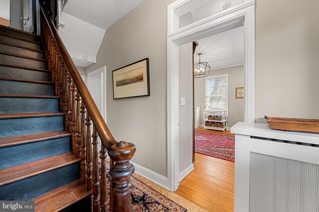 1602 S Rolling Rd, Halethorpe, MD 21227 - staircase featuring a chandelier, wood finished floors, and baseboards