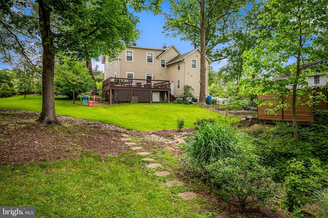 1602 S Rolling Rd, Halethorpe, MD 21227 - back of house with a deck and a lawn