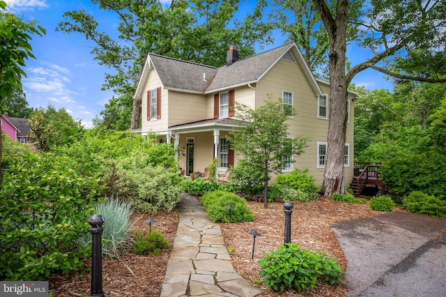 1602 S Rolling Rd, Halethorpe, MD 21227 - view of front of house featuring a shingled roof, a chimney, and a porch