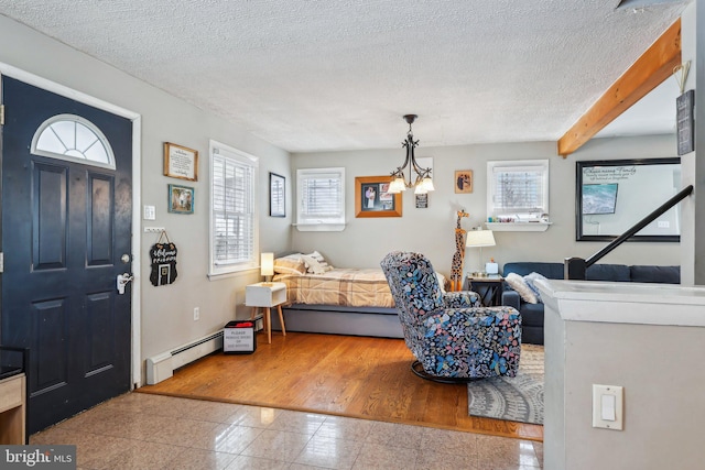 228 Balligomingo Rd, Conshohocken, PA 19428 - foyer featuring a baseboard heating unit, granite tiled floors, a chandelier, a textured ceiling, and baseboards