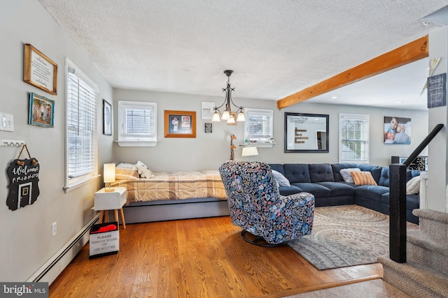 228 Balligomingo Rd, Conshohocken, PA 19428 - living area featuring a textured ceiling, wood finished floors, a chandelier, beamed ceiling, and a baseboard heating unit